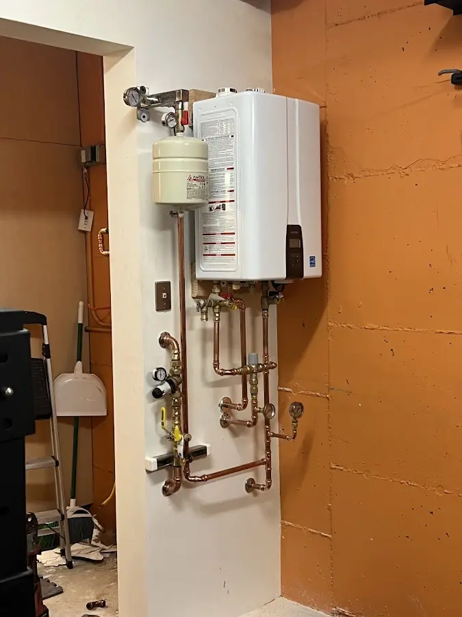 Plumbing technician inspecting water heater connections in Panama City Beach